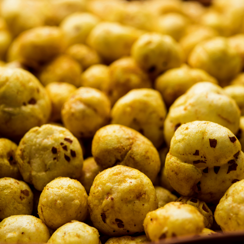 Golden, crunchy snack balls piled together.